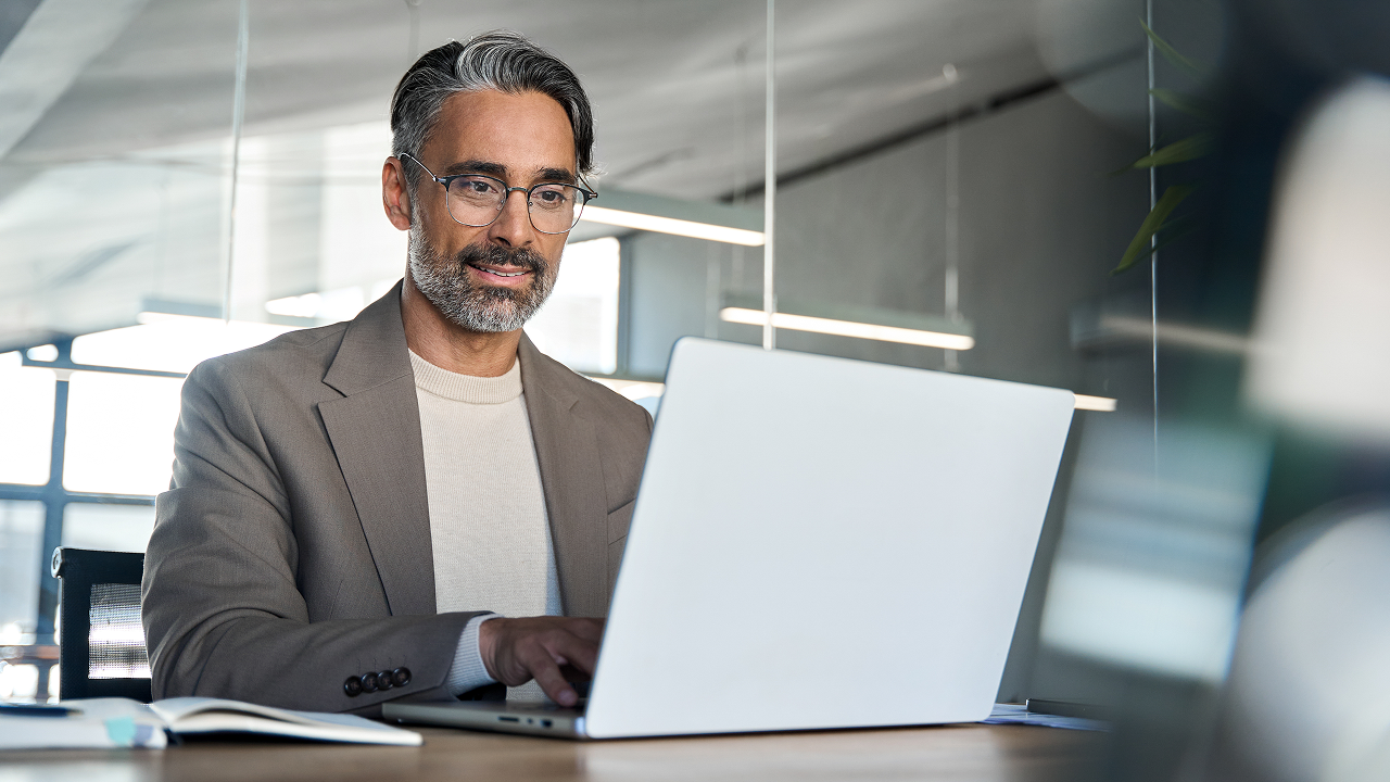 Man in modern office on laptop
