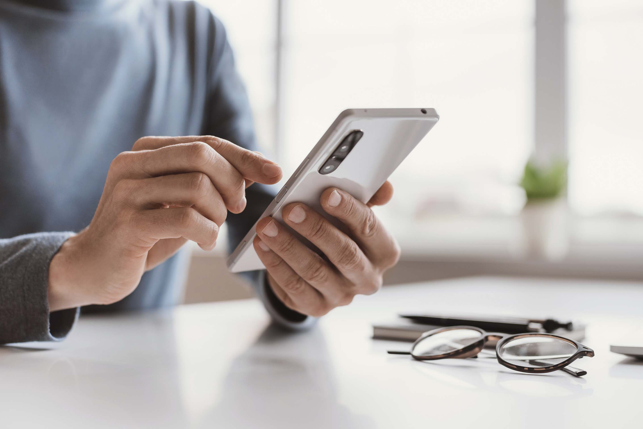 Man tapping on mobile phone