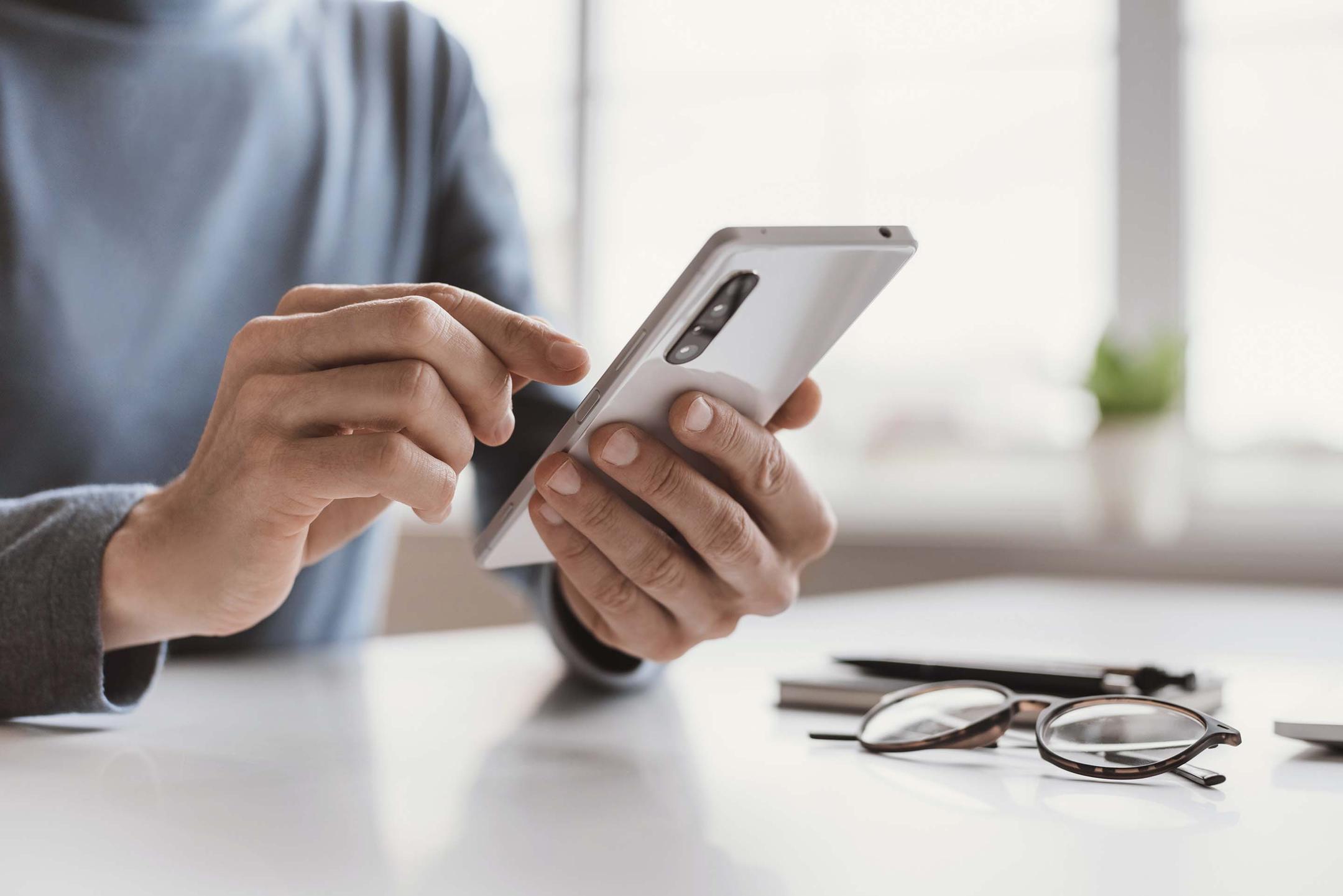 Man tapping on mobile phone